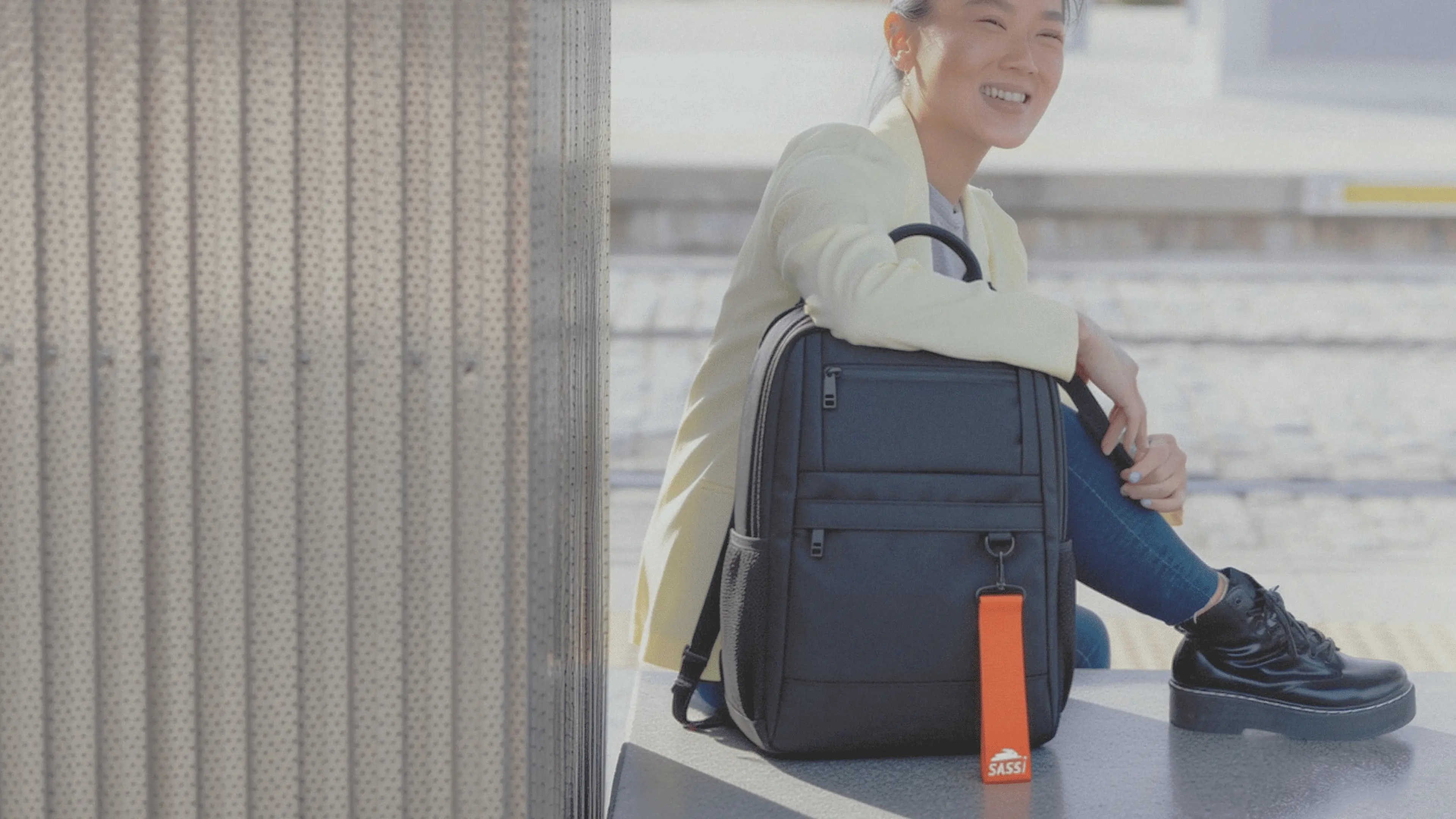 Professional with SASSI backpack seated during a daily commute